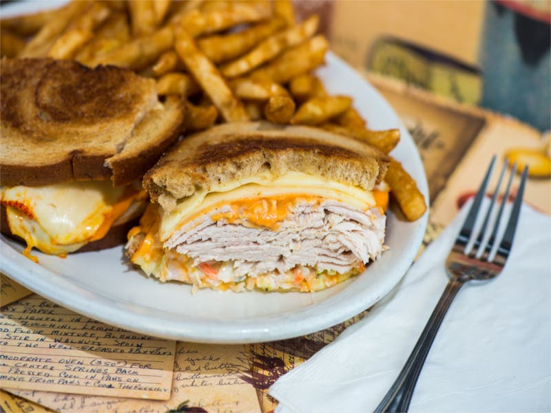 a plate with a sandwich and fries on a table