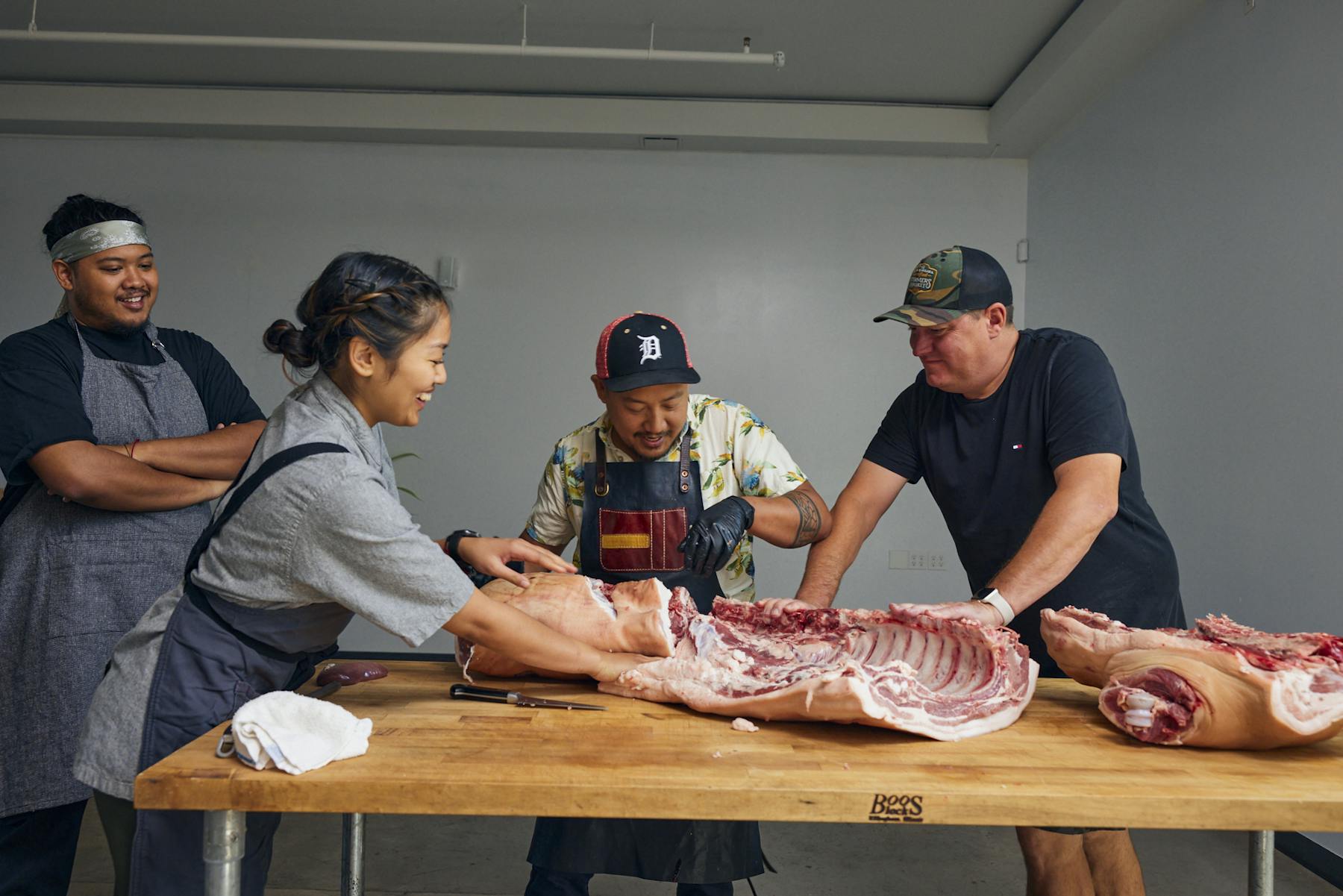 a group of people cutting meat