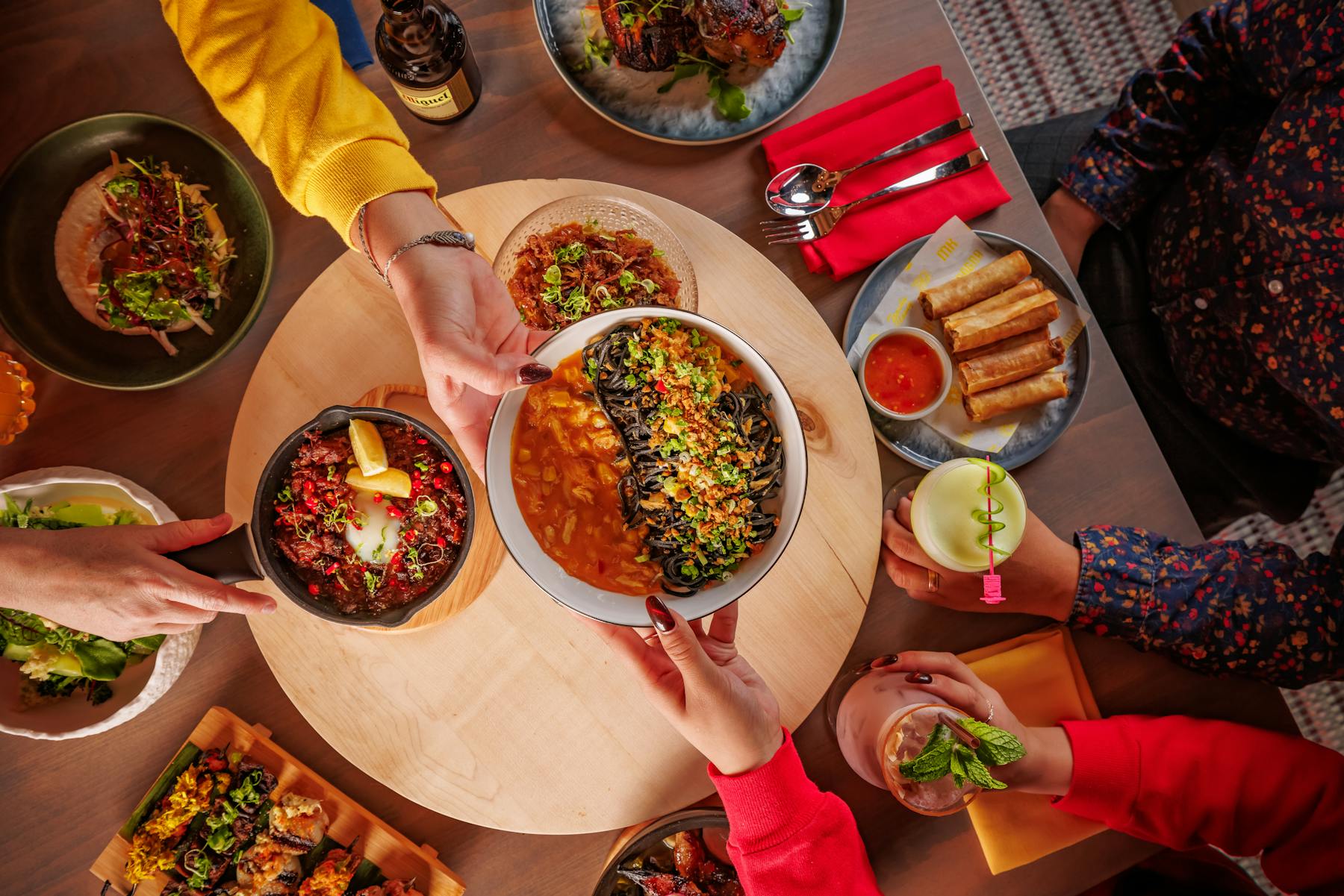 a group of people sitting at a table with a plate of food
