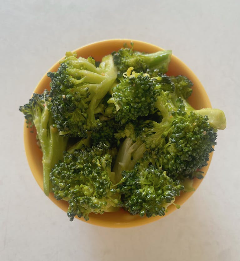 a bowl of food with broccoli