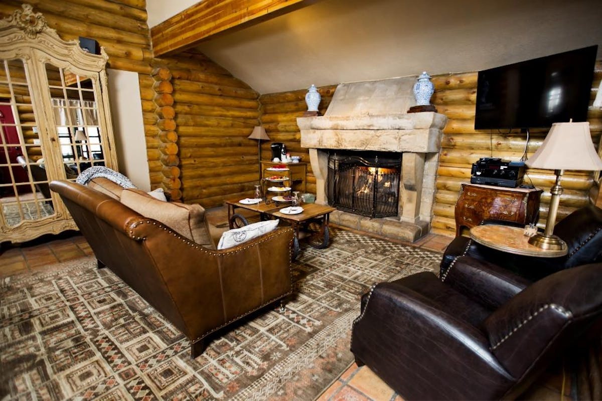 a living room filled with furniture and a fireplace
