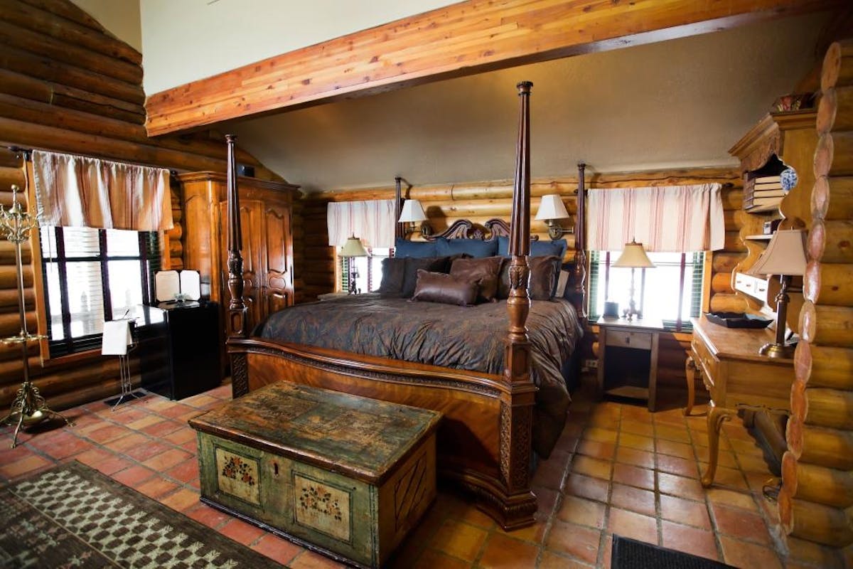 a bedroom with a bed and desk in a room