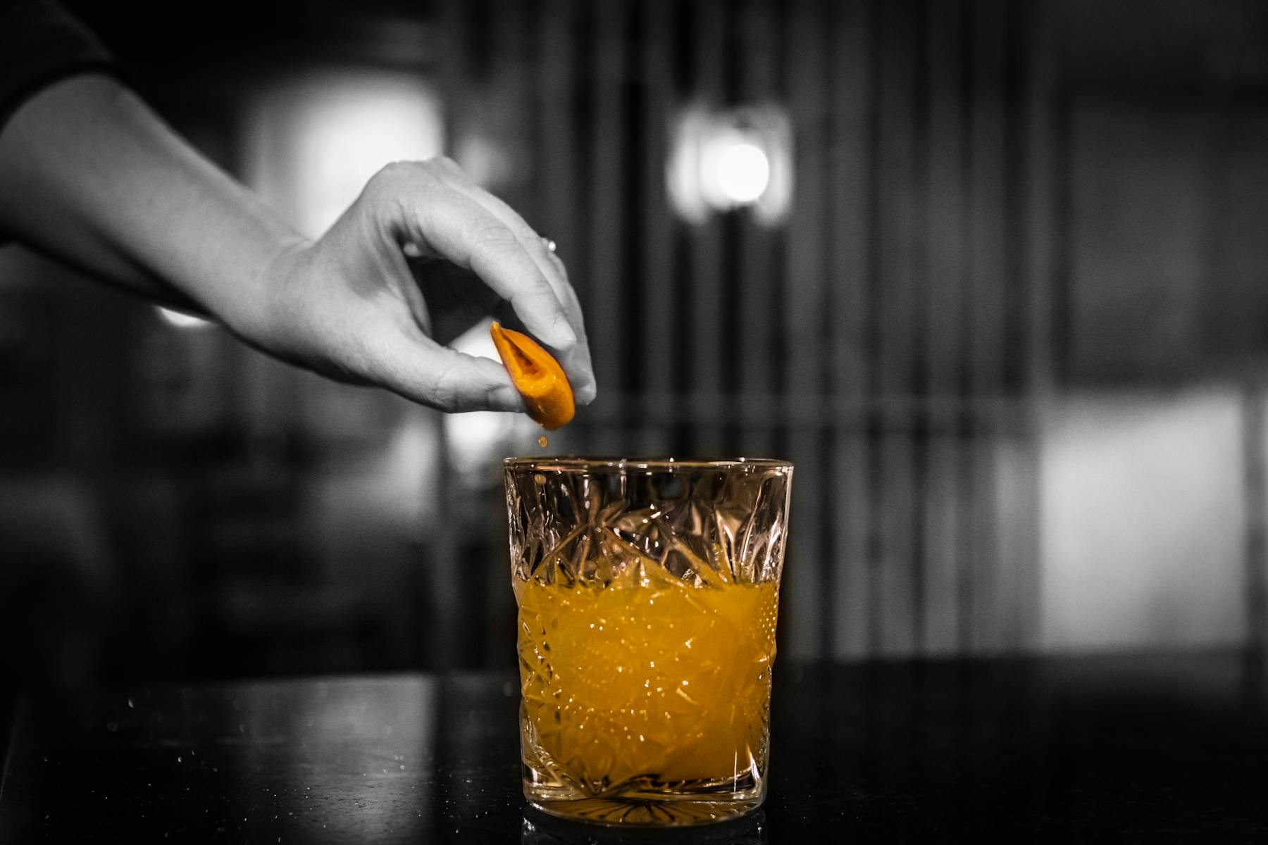 a person holding a glass of orange juice