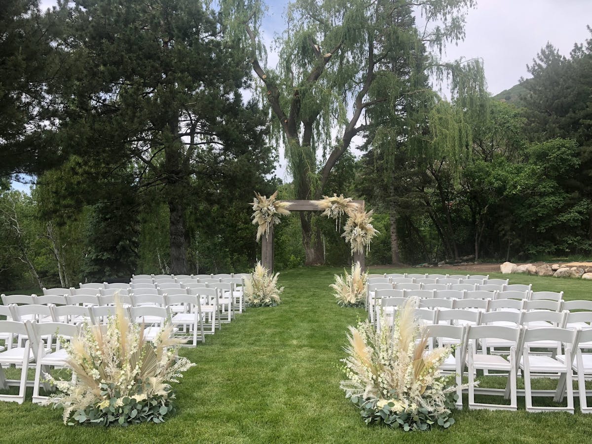 a group of lawn chairs sitting on top of a grass covered field