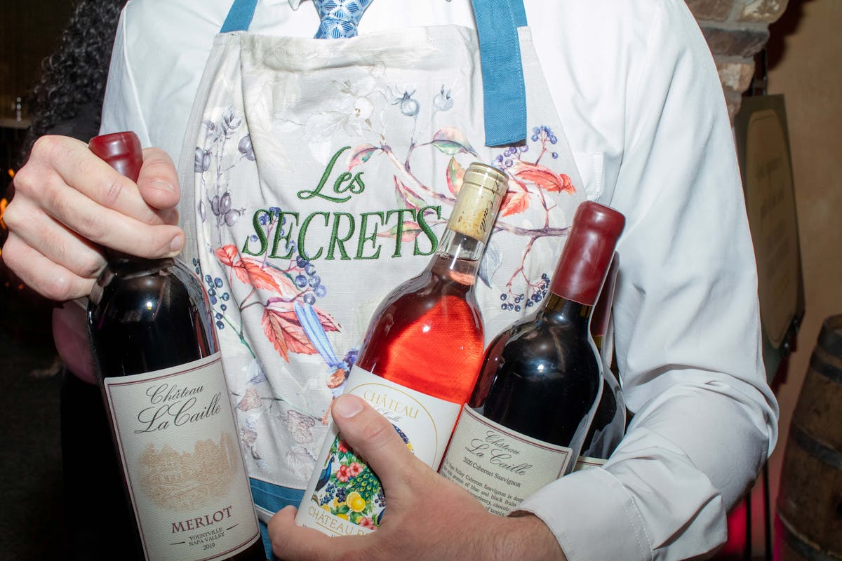 a person holding a bottle of wine