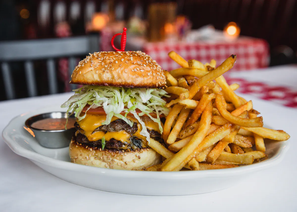 a close up of a sandwich and fries on a plate