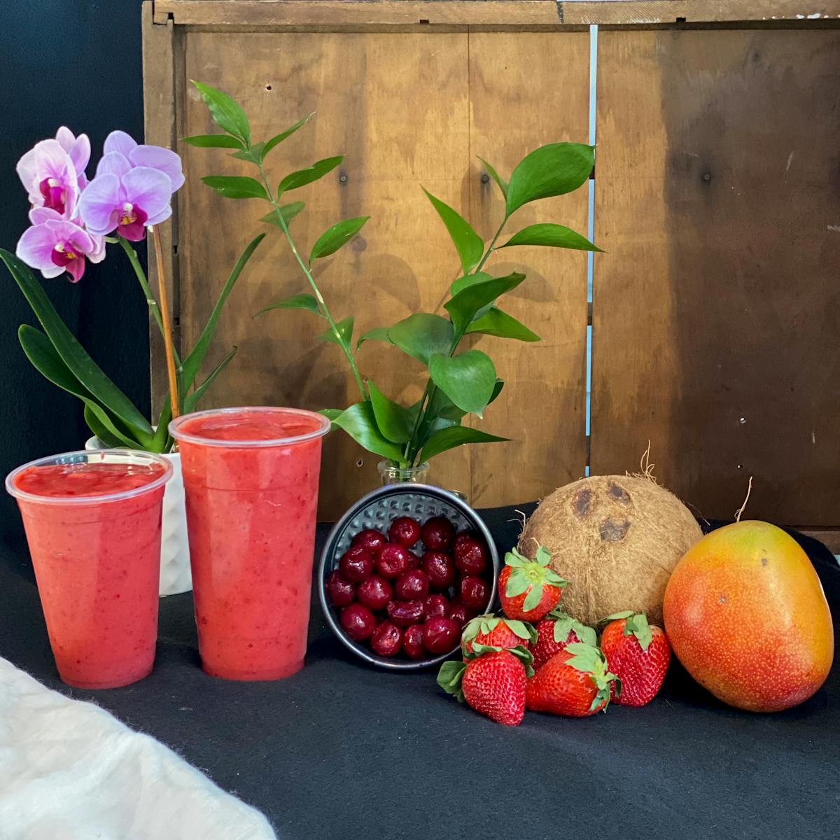 Cherry Mist smoothie and a vase of flowers on a table