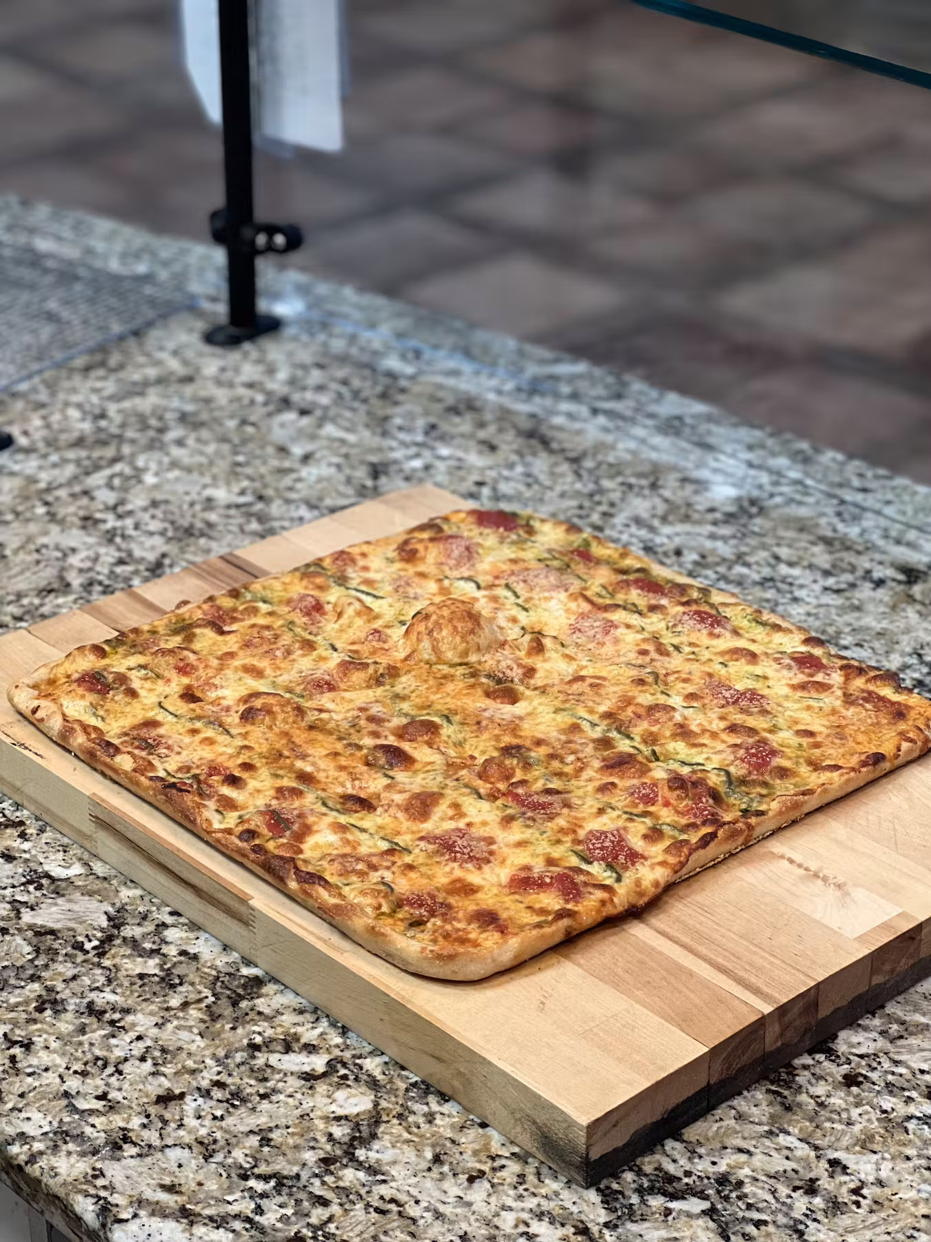 a pizza sitting on top of a wooden table
