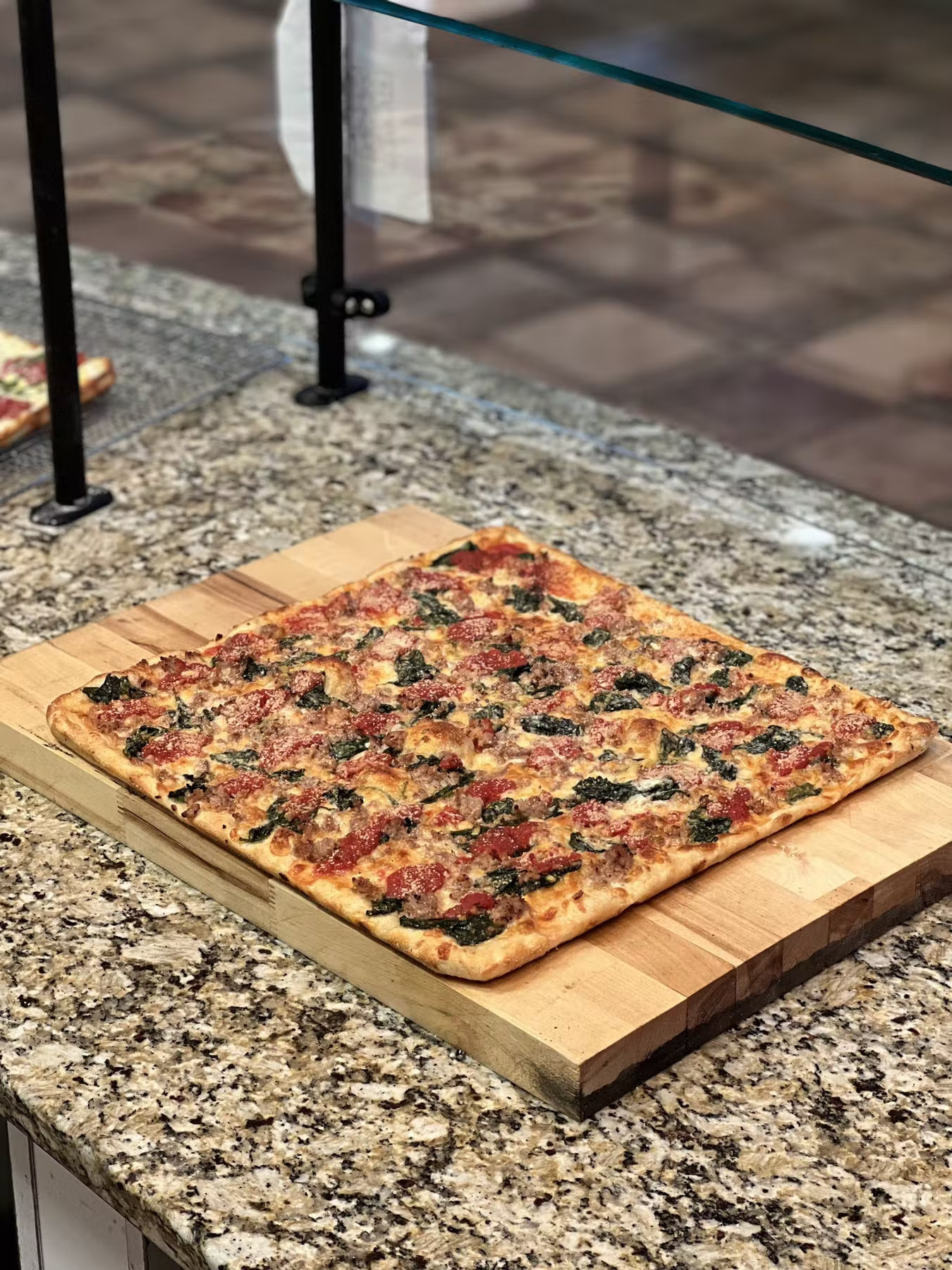 a pizza sitting on top of a wooden table