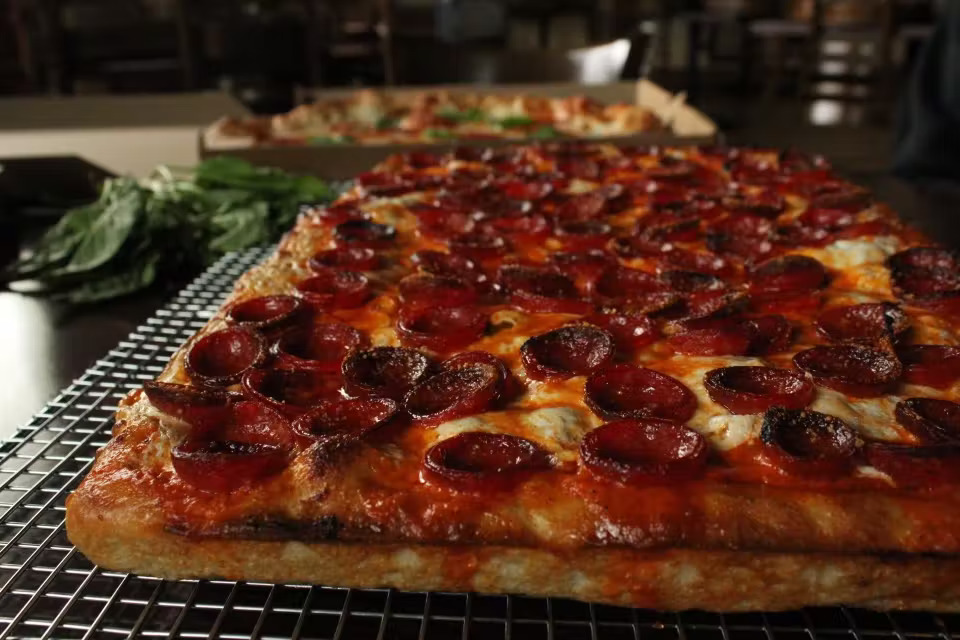 a pepperoni pizza sitting on top of a table