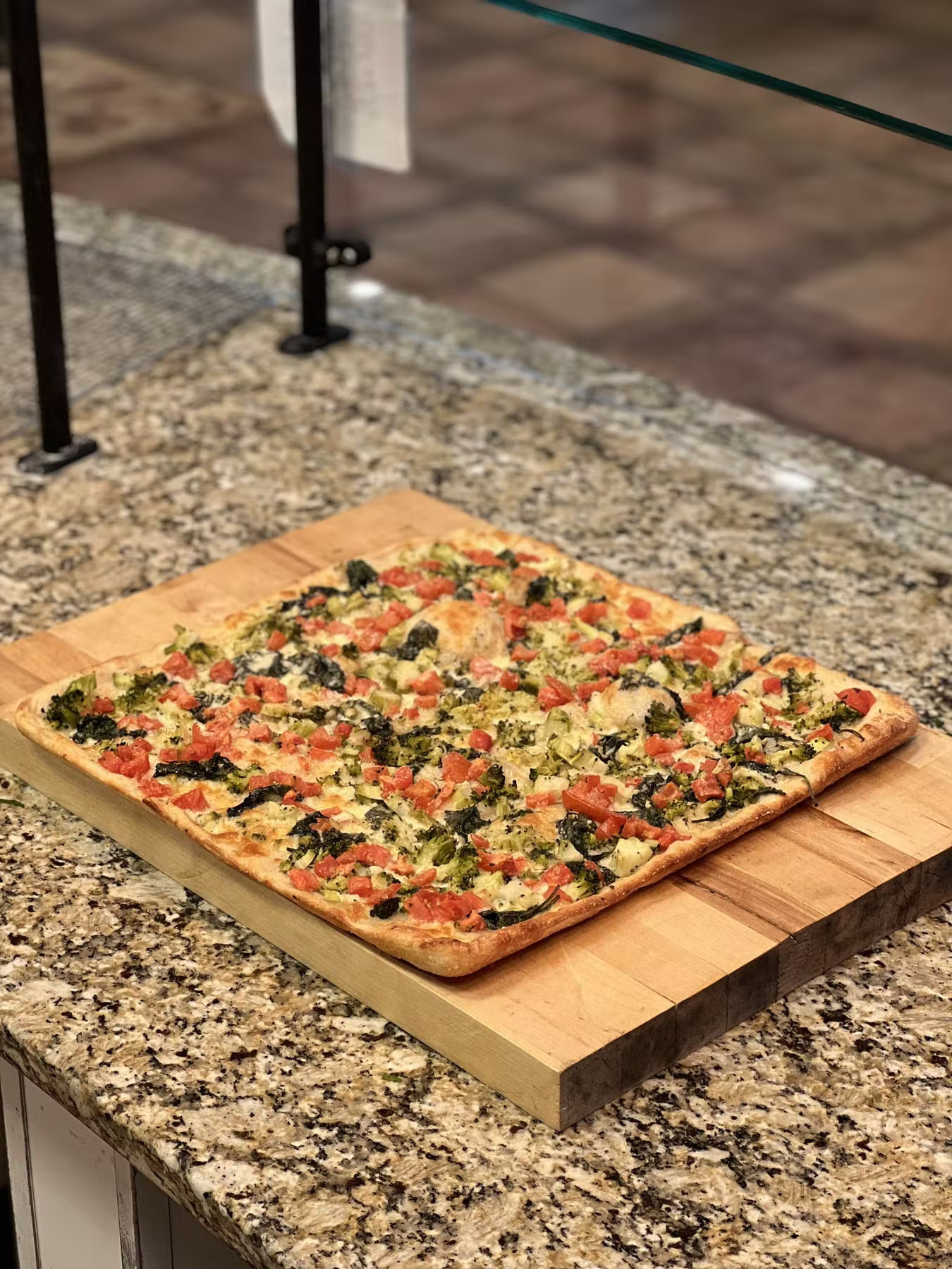 a pizza sitting on top of a wooden table