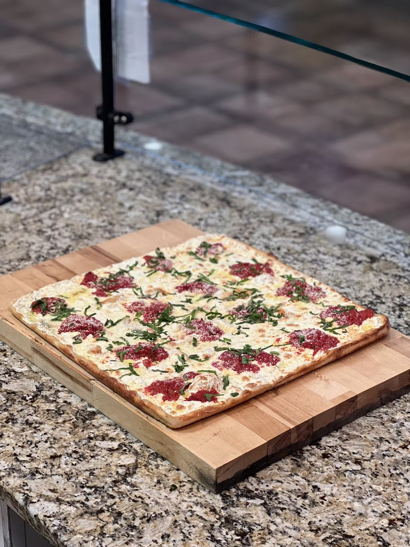 a pizza sitting on top of a wooden table