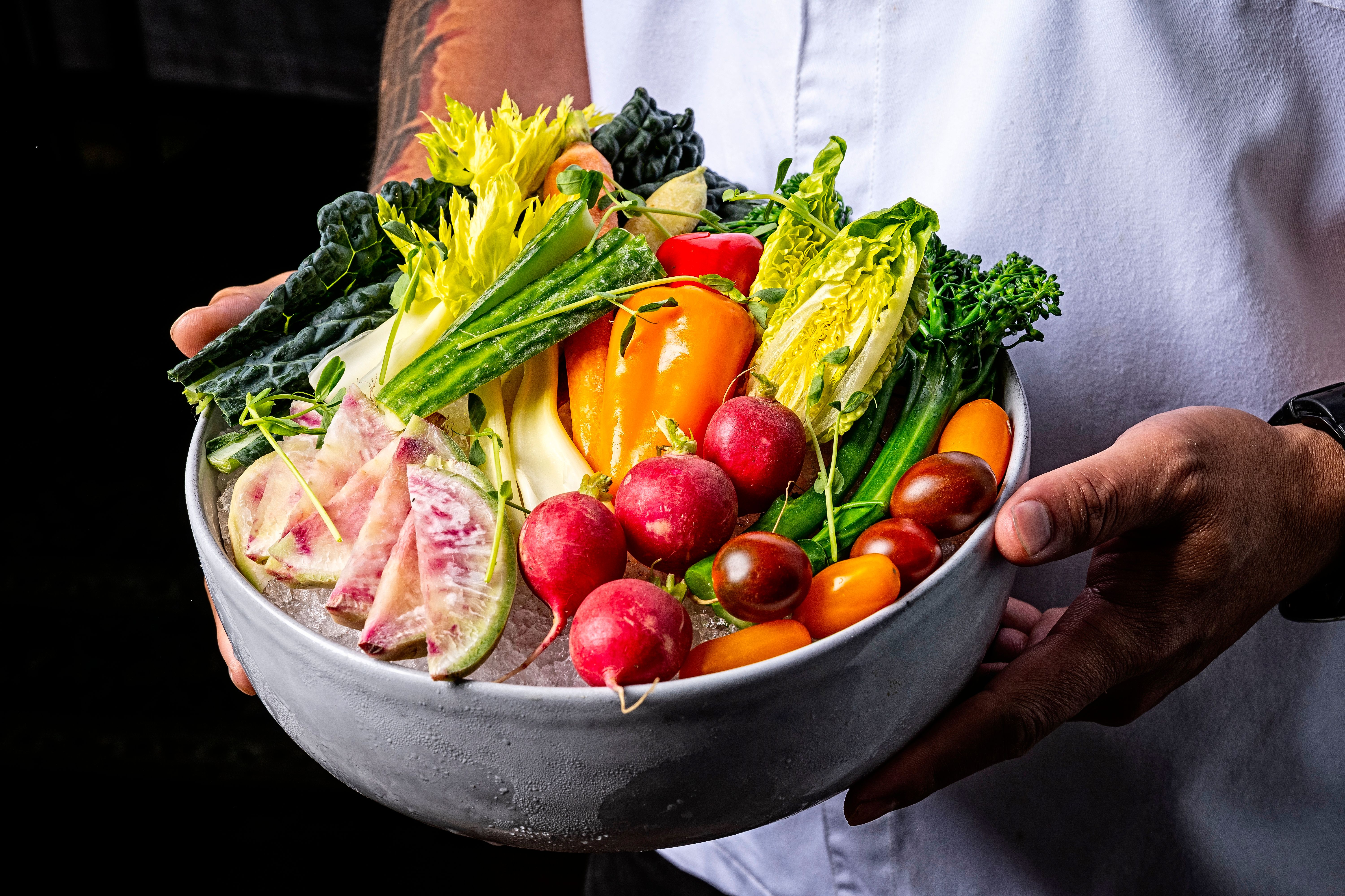 a bowl of fruit and vegetables on a table