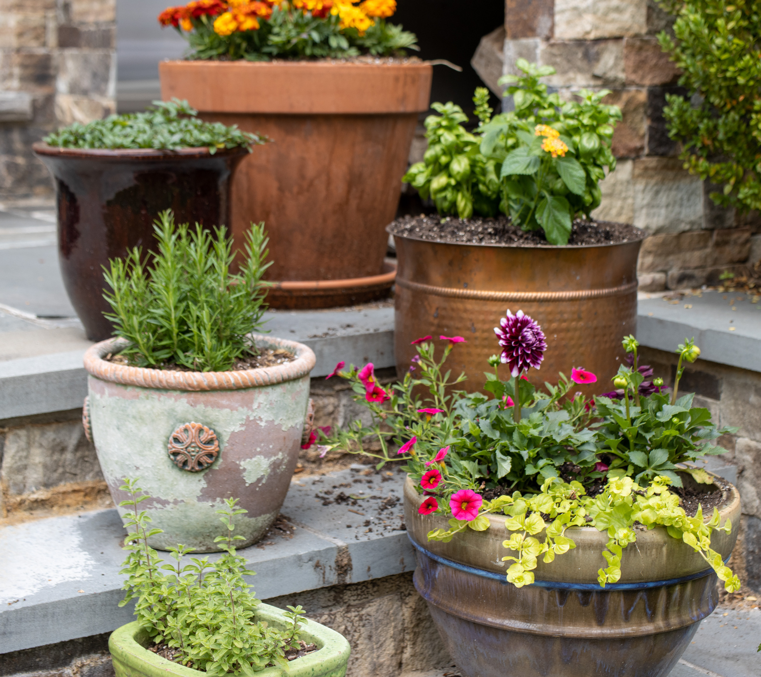 a pot that is sitting on the side of a flower garden