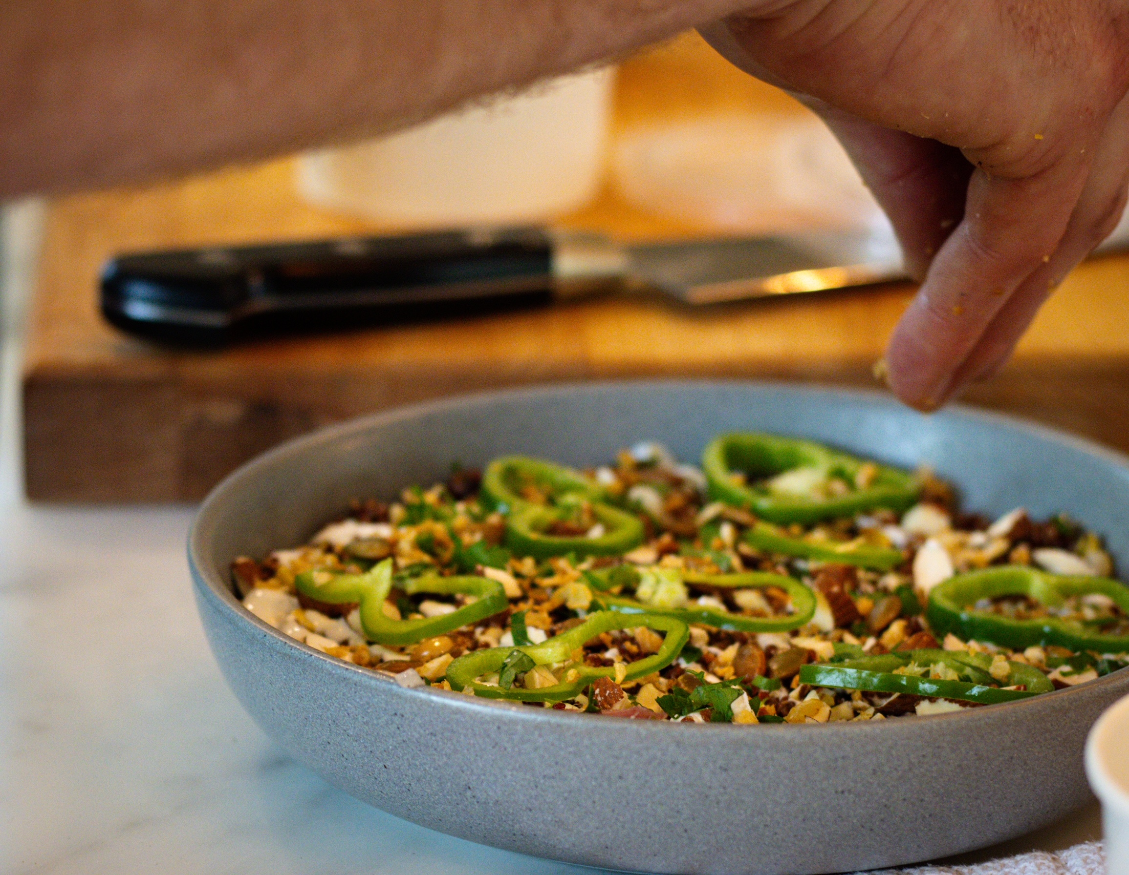 a bowl of food on a cutting board