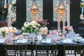 a vase of flowers on a dining table