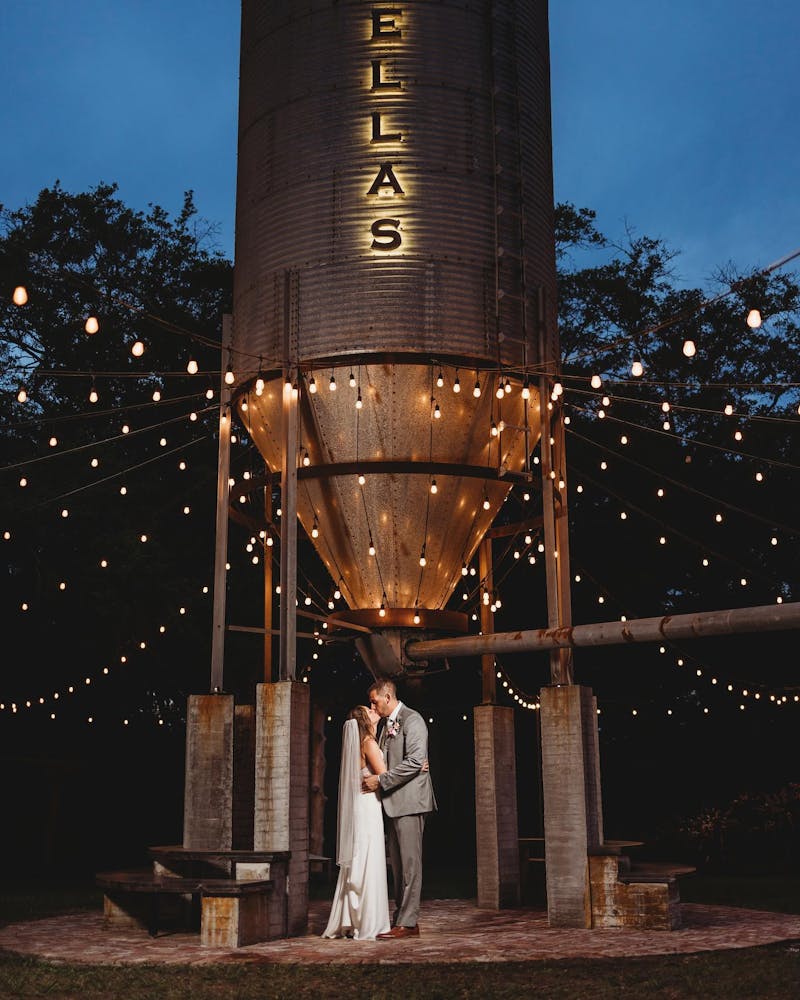 a man standing in front of a tall building