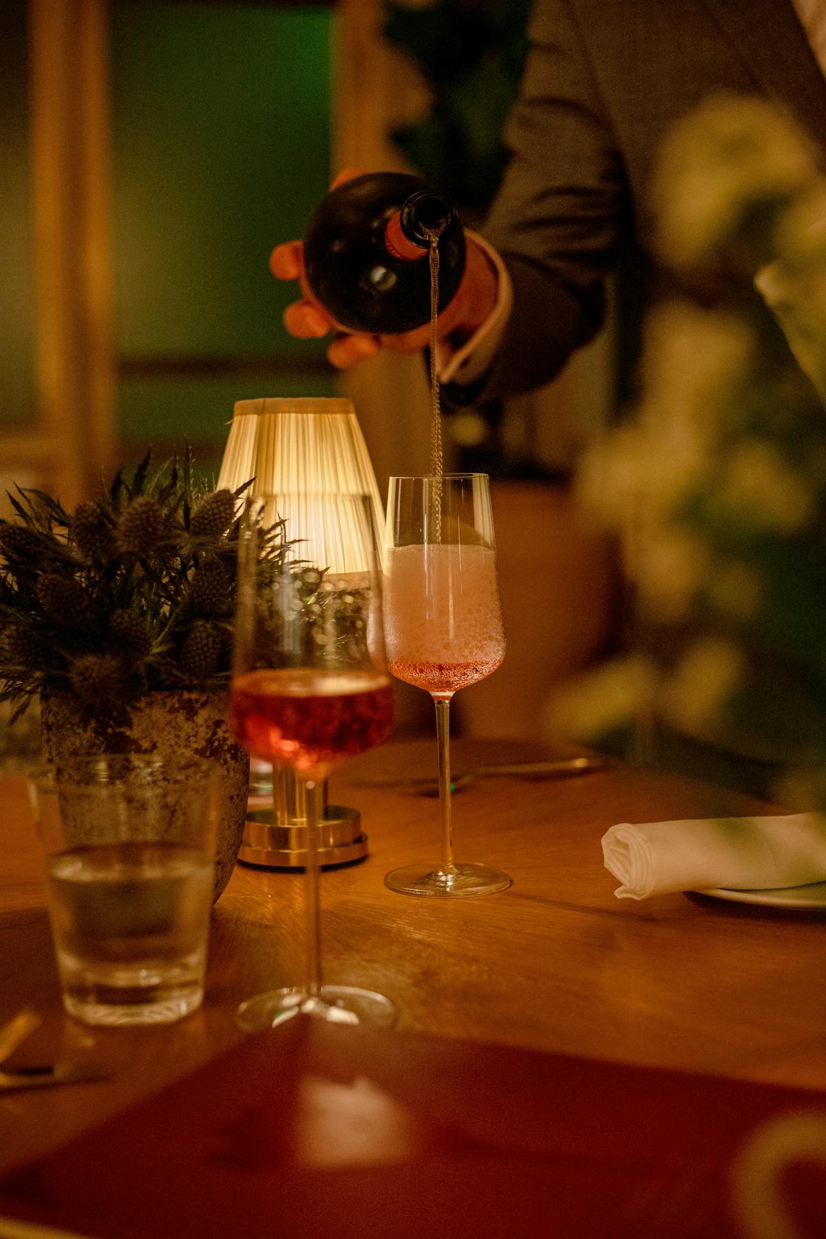 a group of people sitting at a table with wine glasses