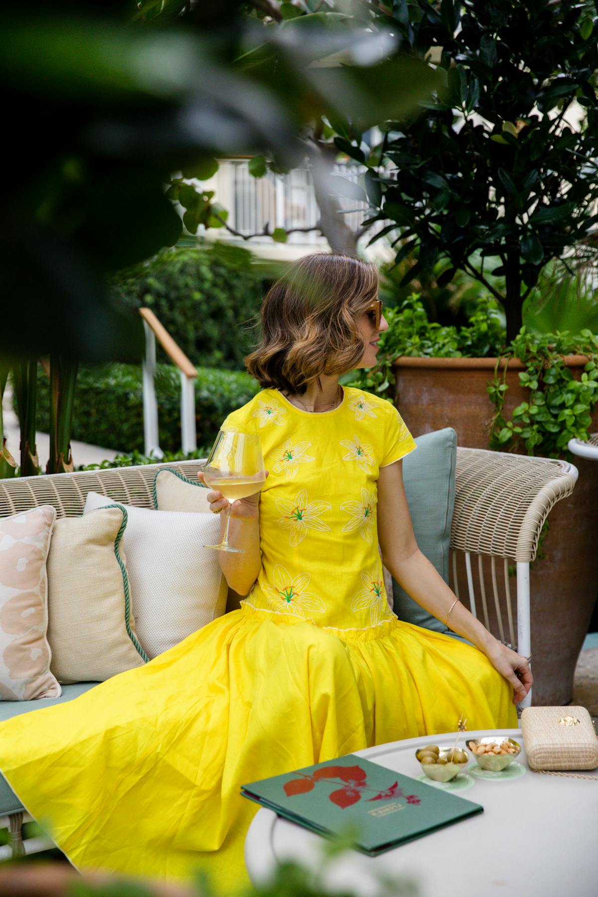 Woman enjoying a glass of wine along Florie's Terrace