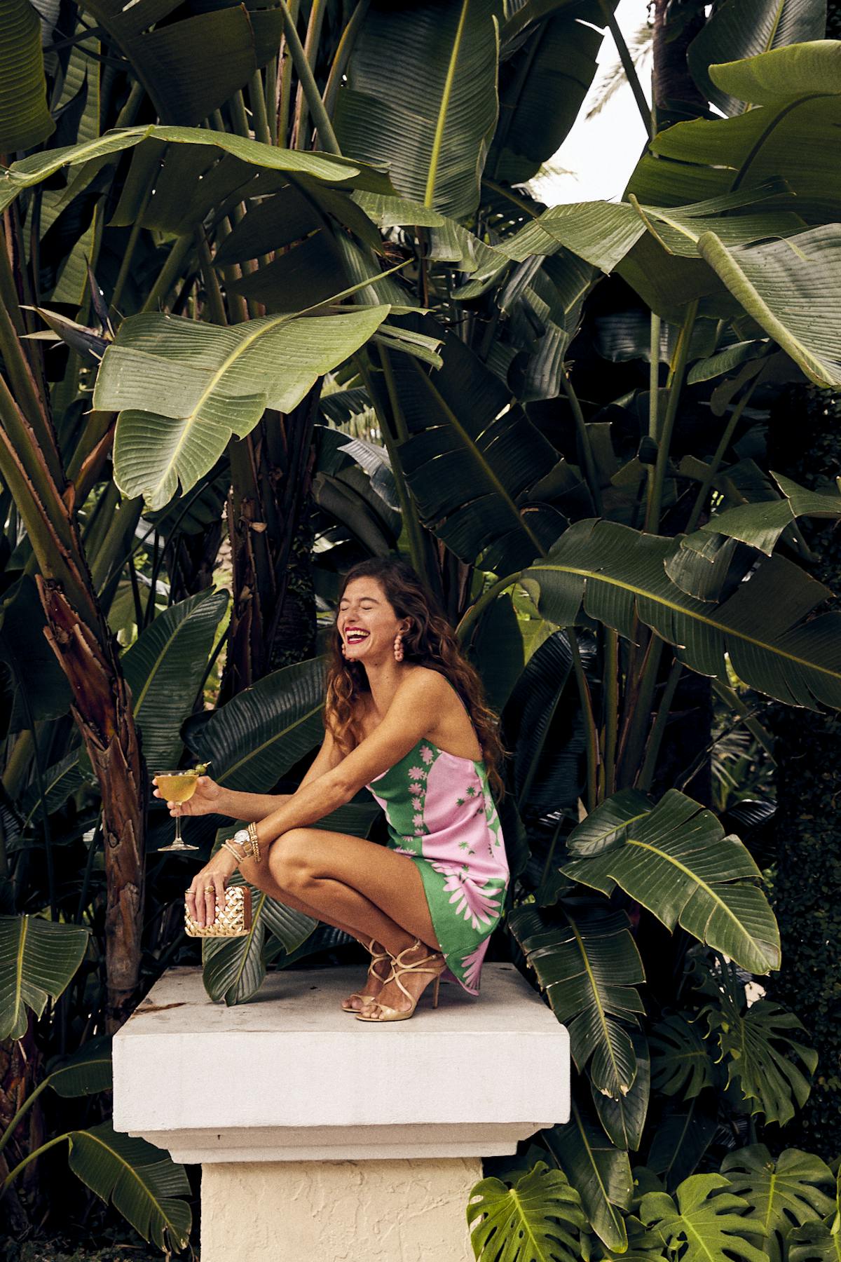 a person sitting next to a palm tree