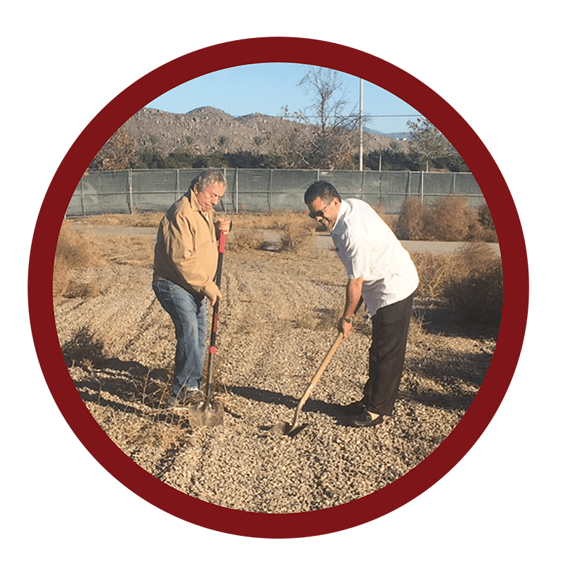 a man riding a bike down a dirt road