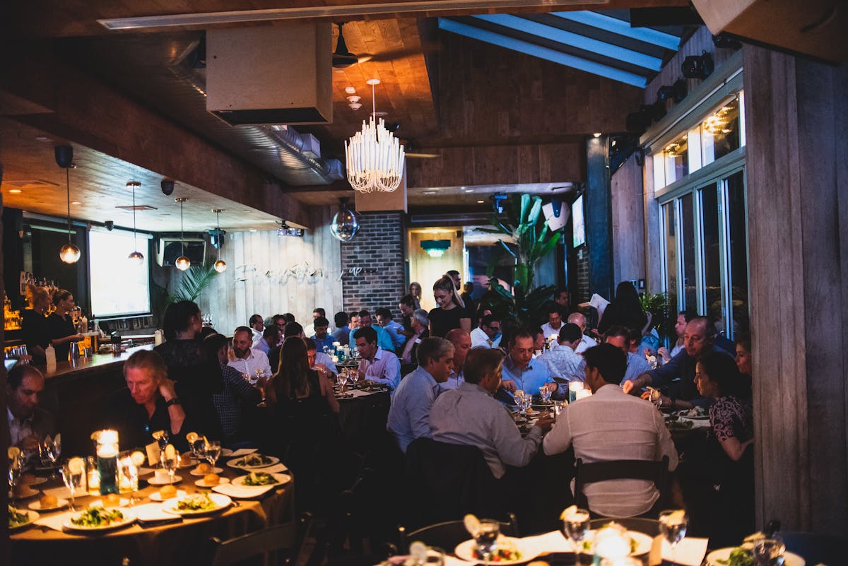 a group of people sitting at a table in a restaurant