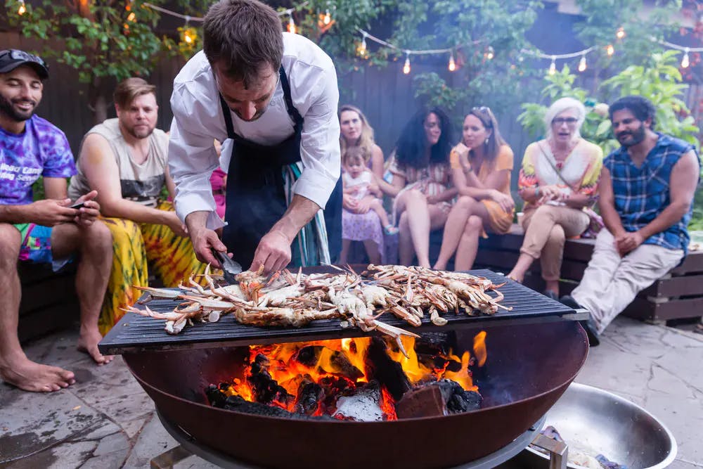 a person cooking food on a grill