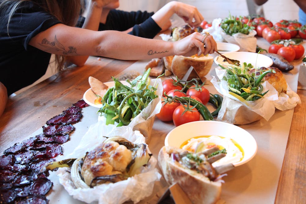 a group of people sitting at a table with a plate of food