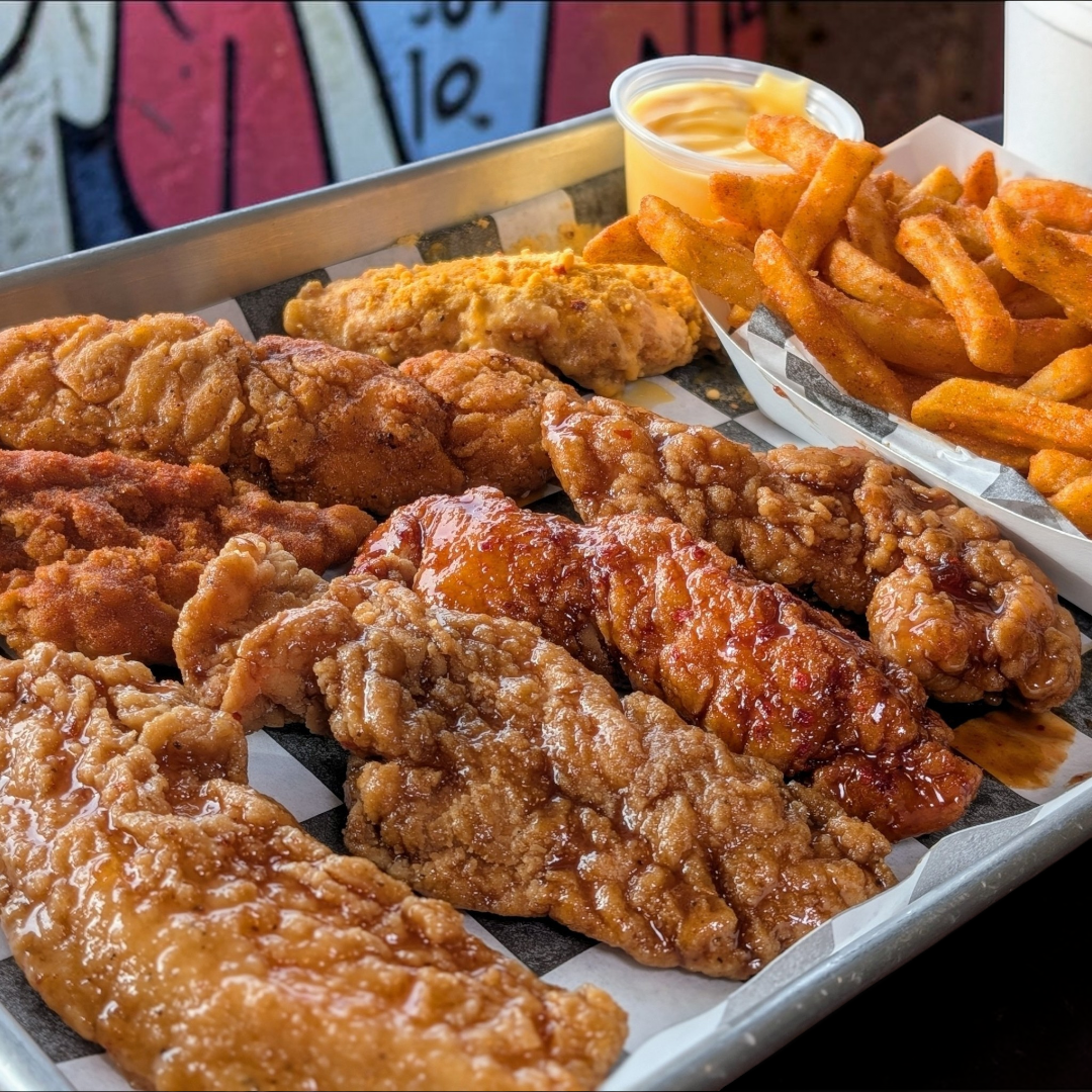 a tray of fried chicken and fries