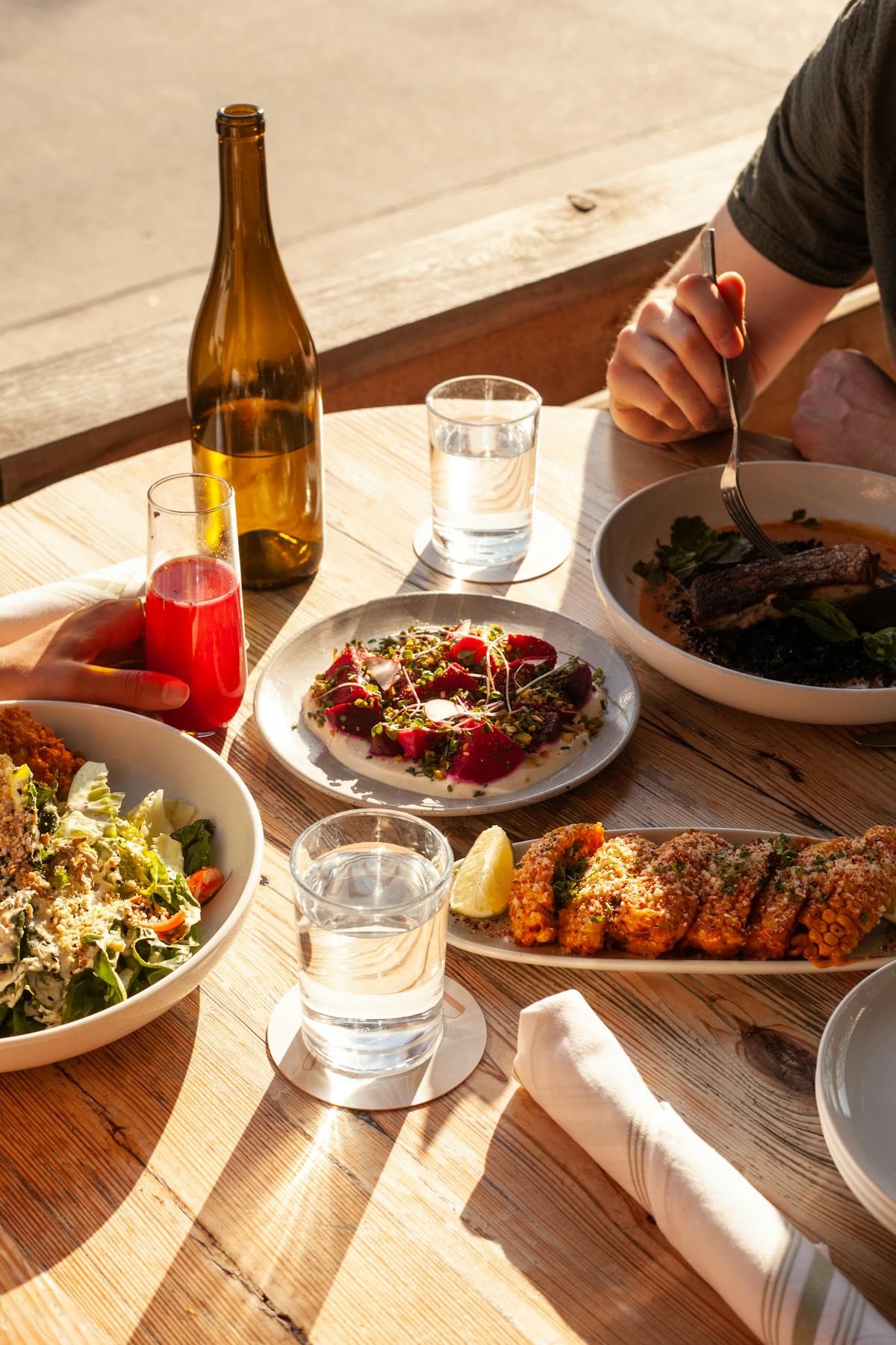 a person sitting at a table with a plate of food