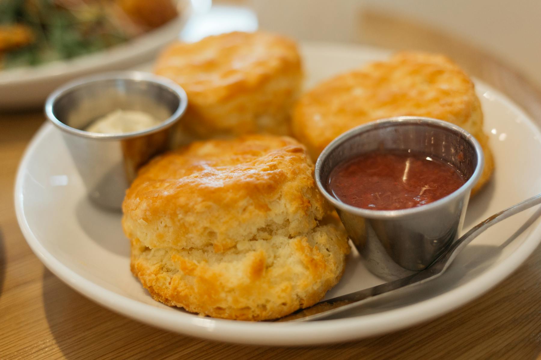 a close up of a plate topped with hash browns nuggets and sauces