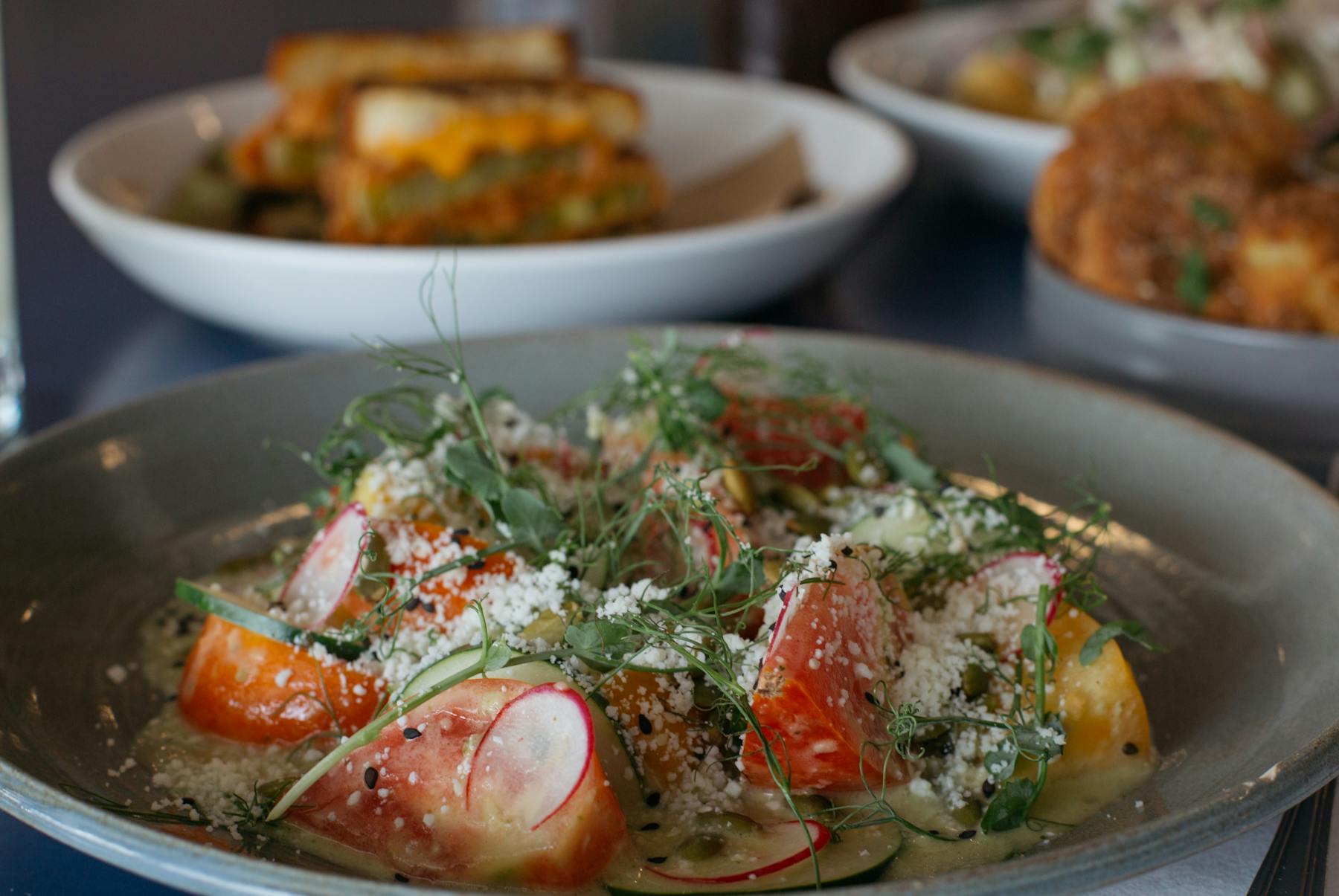 a bowl topped with a salad and shrimps