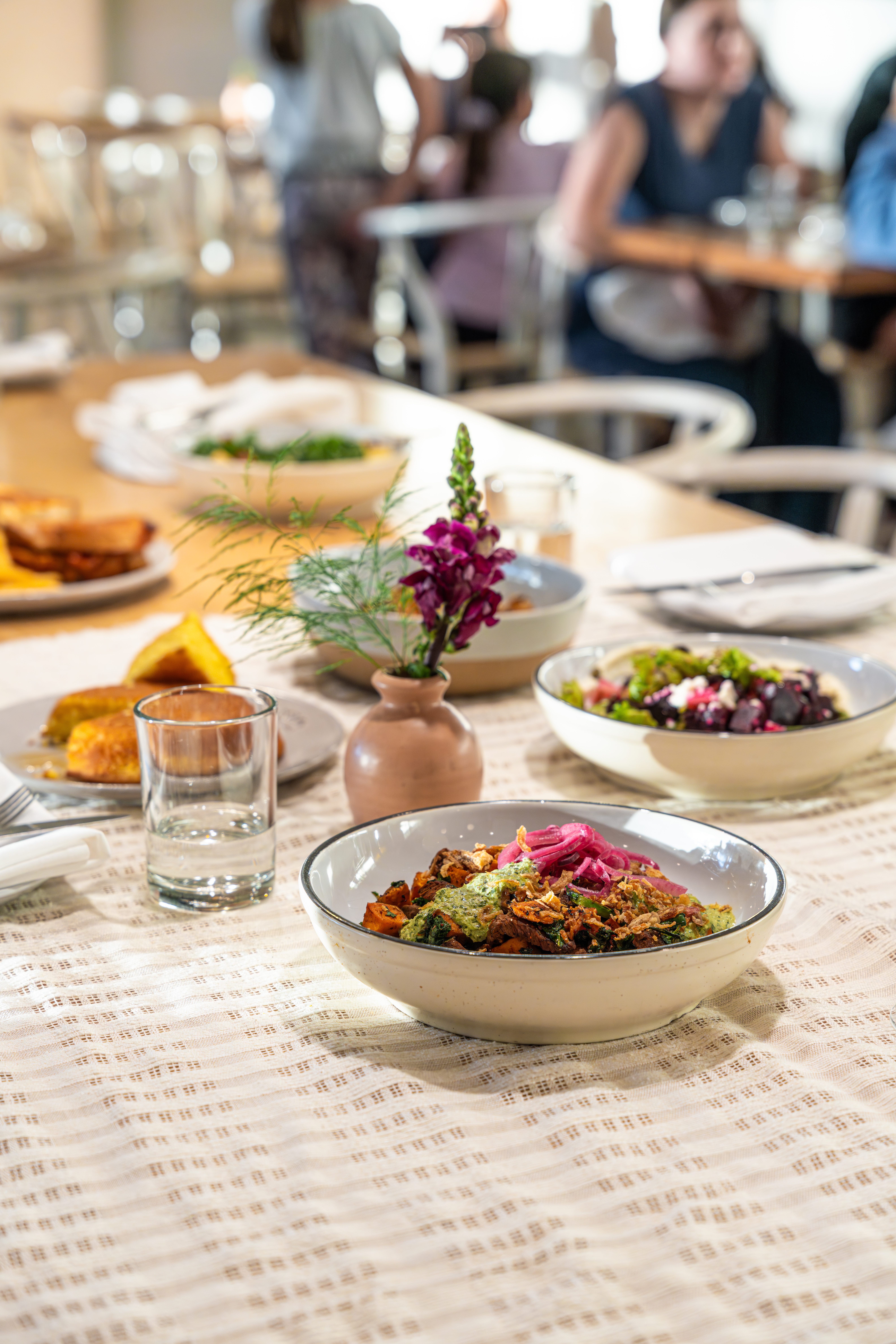 a table with plates of food and glasses