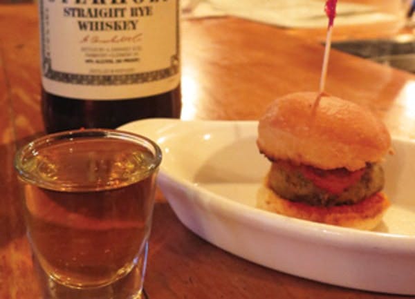 a plate of food and a glass of beer on a table