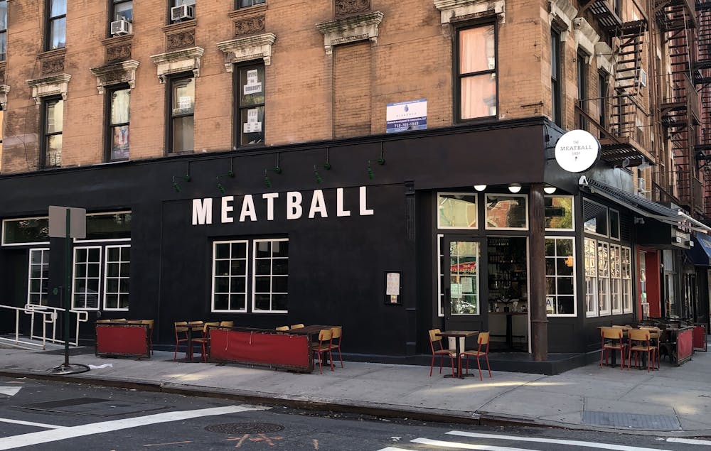 a close up of a street in front of a brick building