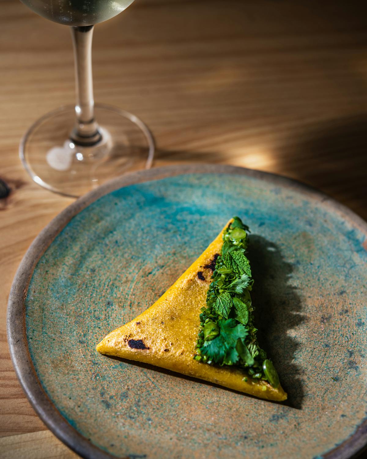 a close up of a wine glass sitting on a plate