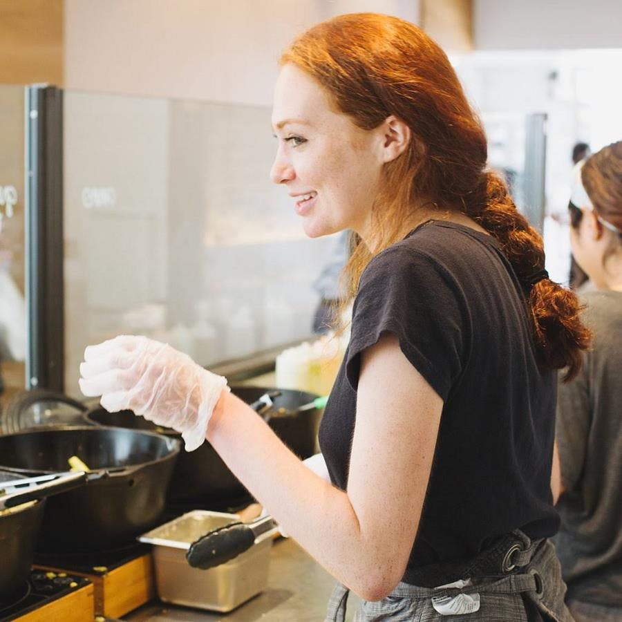 a person cooking in a kitchen preparing food