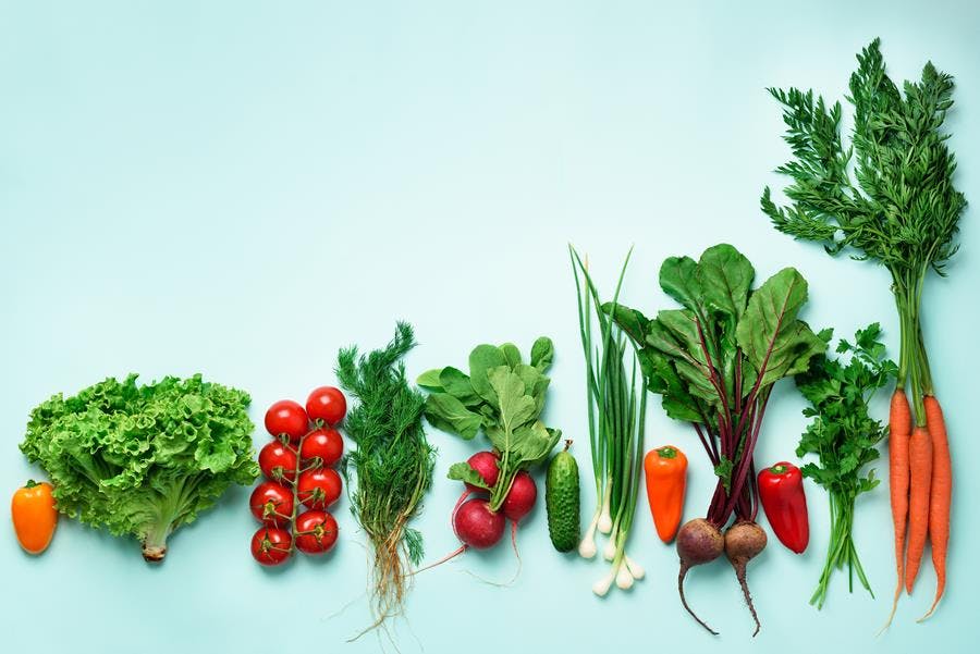 a table topped with lots of fresh vegetables