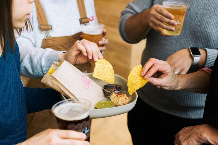 a woman sitting at a table with a plate of food
