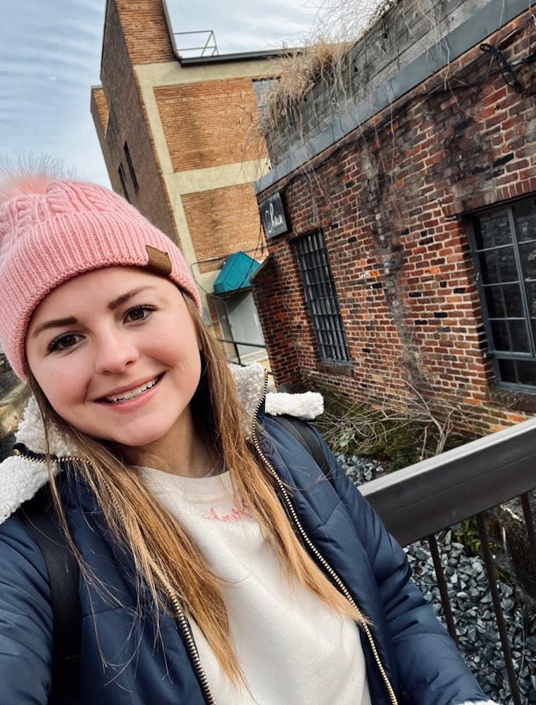 a girl wearing a hat and smiling at the camera
