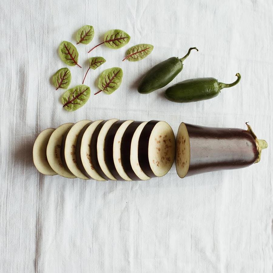 a banana sitting on top of a wooden cutting board