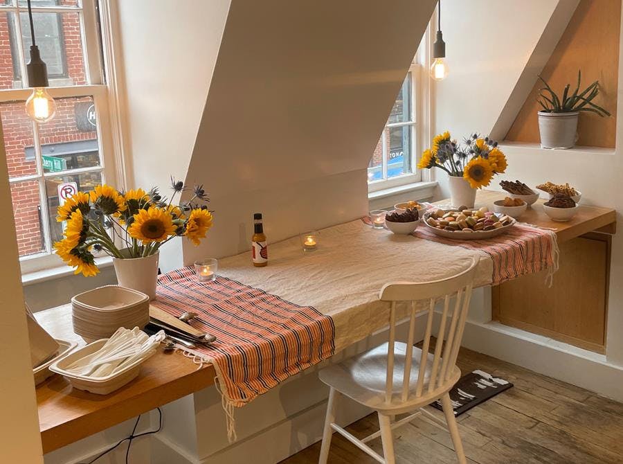 a room filled with furniture and vase of flowers on a table