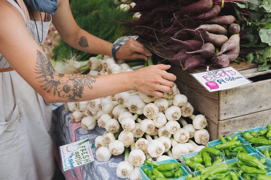 a person standing in front of a produce stand