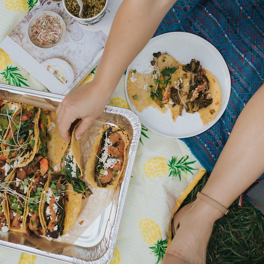 a woman holding a plate of food