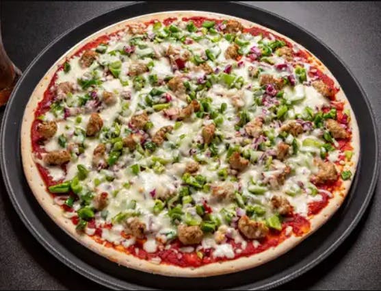 a pizza sitting on top of a pan on a table