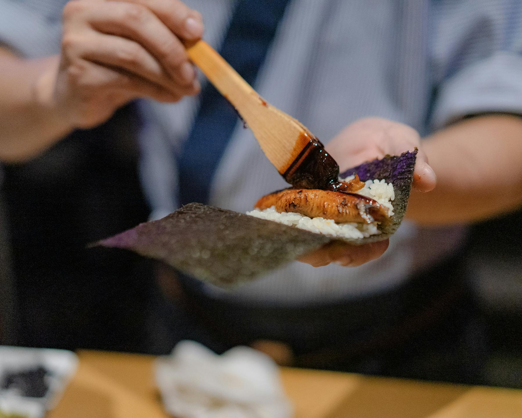 a hand holding a fork and knife