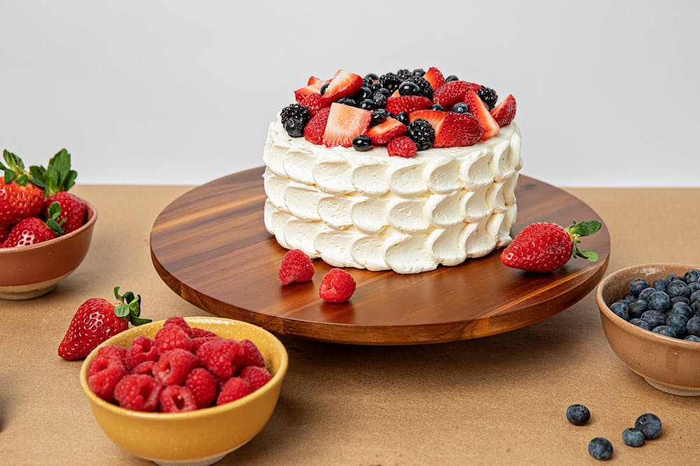 a cake with fruit on top of a table