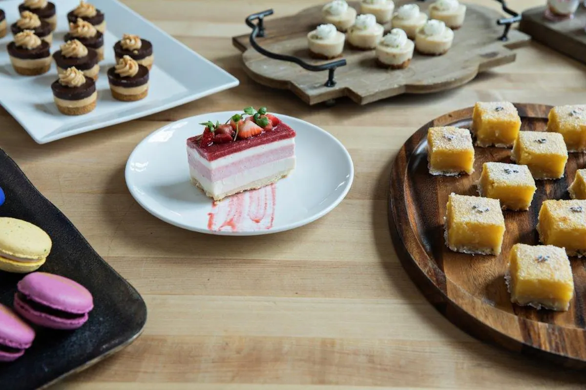 a wooden table topped with plates of food on a plate