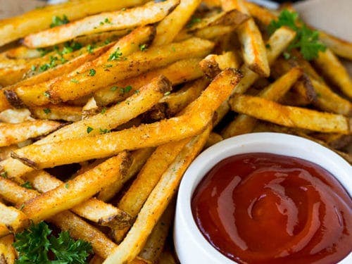 a close up of a sandwich and fries on a plate