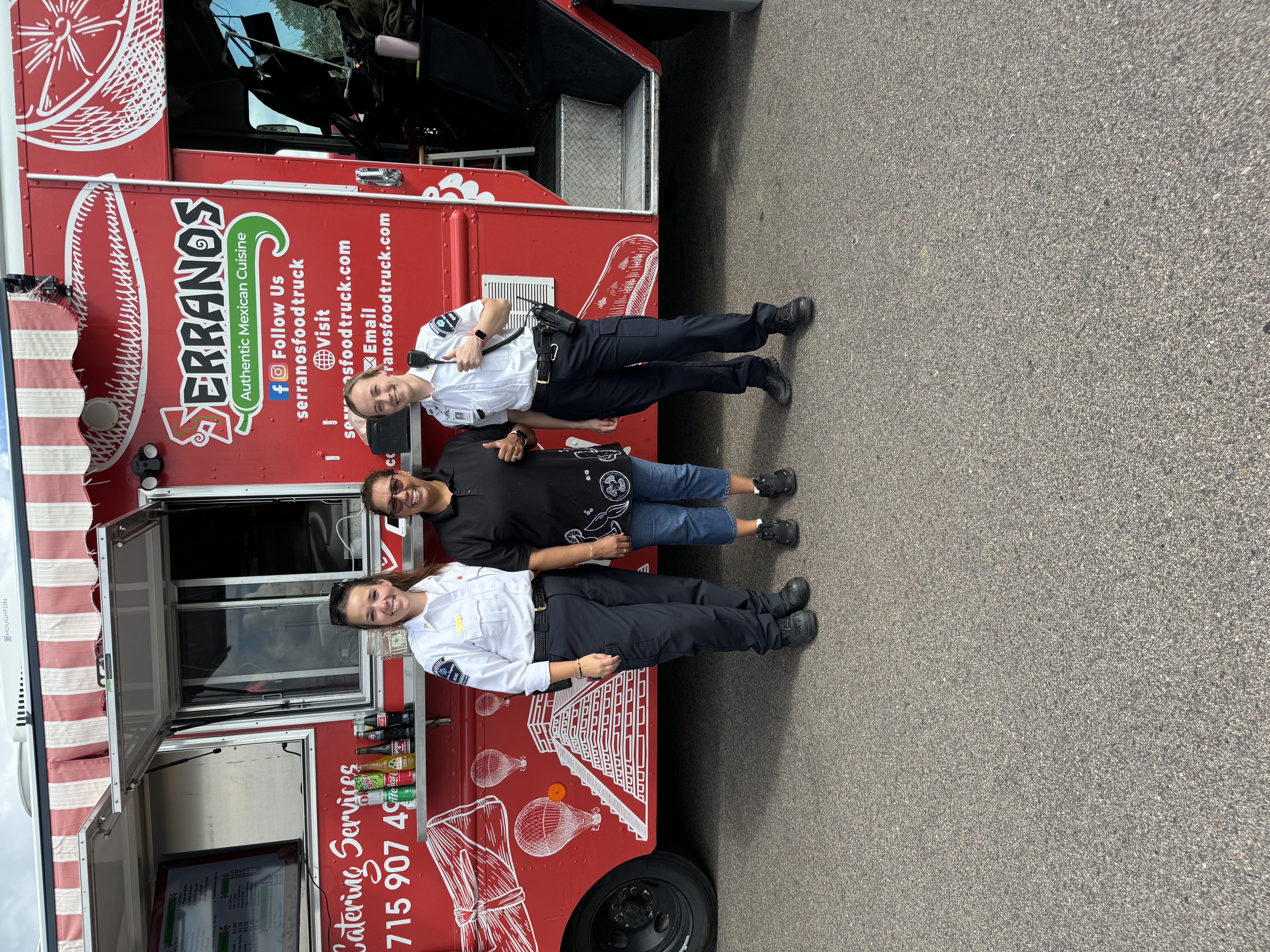 a group of people standing in front of a truck